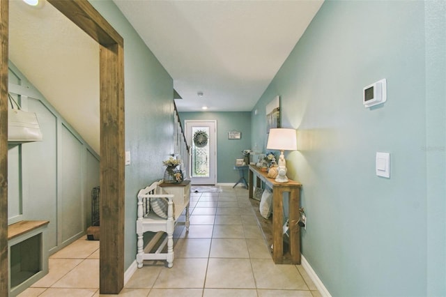 entrance foyer featuring light tile patterned flooring and baseboards