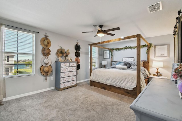 bedroom with a ceiling fan, baseboards, visible vents, and carpet floors