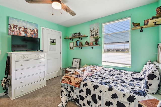 carpeted bedroom with multiple windows and a ceiling fan