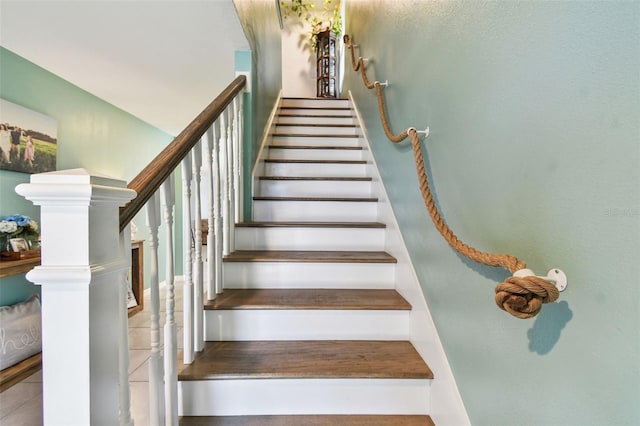 stairway featuring tile patterned flooring