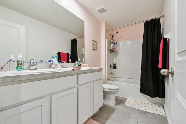 bathroom featuring tile patterned floors, visible vents, shower / tub combo with curtain, toilet, and a sink