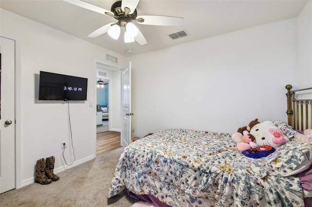 bedroom with visible vents, carpet flooring, and a ceiling fan