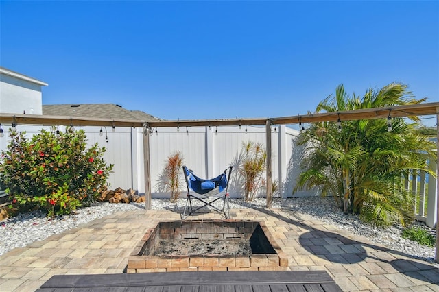 view of patio / terrace with fence private yard and an outdoor fire pit