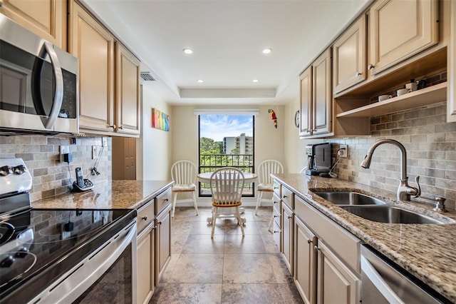 kitchen featuring baseboards, visible vents, open shelves, a sink, and stainless steel appliances