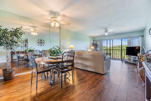 dining space with wood-type flooring, a textured ceiling, and a ceiling fan