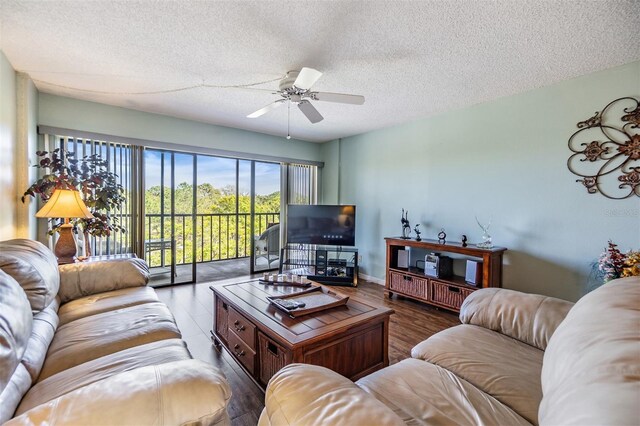 living room featuring a textured ceiling, a ceiling fan, and wood finished floors