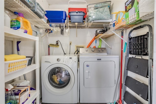 clothes washing area with washer and dryer and laundry area