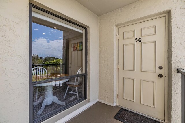 view of exterior entry featuring stucco siding