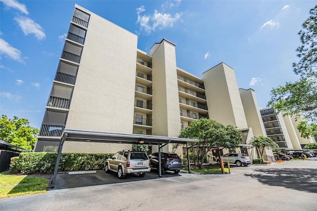 view of building exterior with covered parking