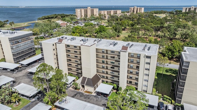 birds eye view of property featuring a view of city and a water view