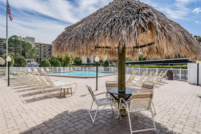 community pool featuring a gazebo, a patio area, and fence