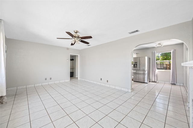 3310 W Swann Ave, Tampa, FL 33609 - spare room with a ceiling fan, baseboards, visible vents, light tile patterned flooring, and arched walkways