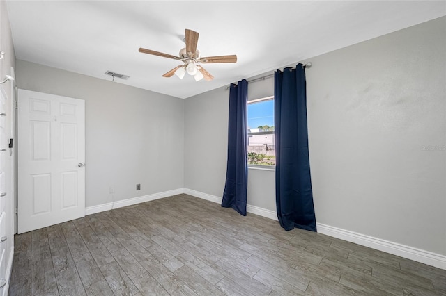 3310 W Swann Ave, Tampa, FL 33609 - spare room with visible vents, baseboards, a ceiling fan, and wood finished floors