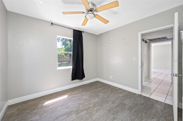 3310 W Swann Ave, Tampa, FL 33609 - spare room with a ceiling fan, wood finished floors, and baseboards