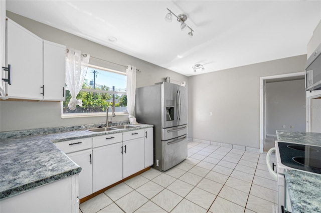 3310 W Swann Ave, Tampa, FL 33609 - kitchen featuring white range with electric stovetop, stainless steel fridge with ice dispenser, white cabinetry, and a sink
