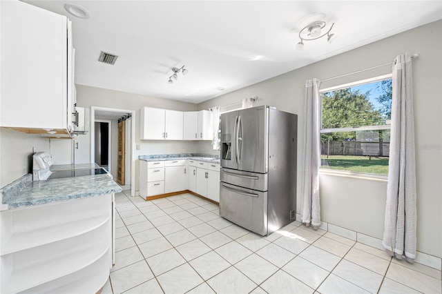 3310 W Swann Ave, Tampa, FL 33609 - kitchen featuring visible vents, open shelves, stainless steel fridge with ice dispenser, light countertops, and stove