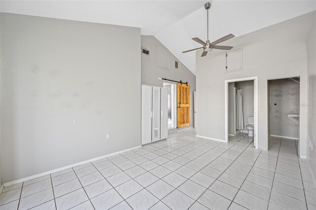 3310 W Swann Ave, Tampa, FL 33609 - unfurnished bedroom featuring light tile patterned floors, baseboards, visible vents, high vaulted ceiling, and ensuite bathroom