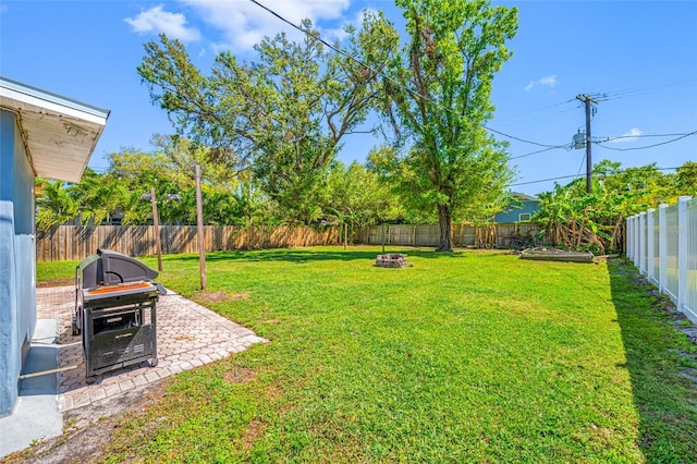 3310 W Swann Ave, Tampa, FL 33609 - view of yard with a patio area, a fire pit, and a fenced backyard