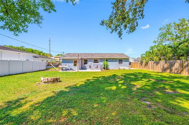 3310 W Swann Ave, Tampa, FL 33609 - back of house with a patio, a fenced backyard, and a lawn