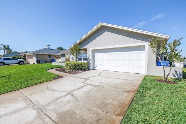 view of front facade with a garage, driveway, a front lawn, and stucco siding