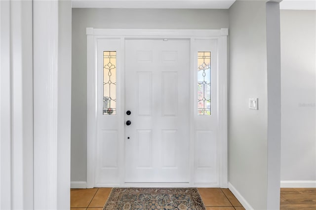 entryway featuring light tile patterned flooring and baseboards
