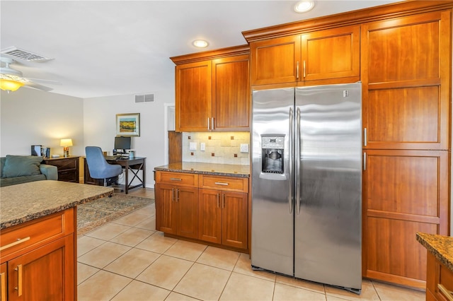 kitchen with light tile patterned floors, visible vents, backsplash, and stainless steel fridge with ice dispenser