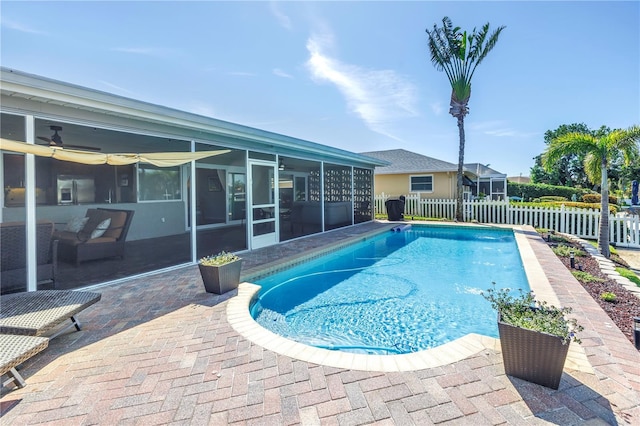 view of pool with a fenced in pool, a patio, a fenced backyard, and a sunroom