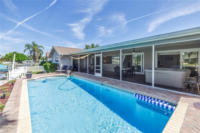 pool featuring a patio, fence, and a sunroom