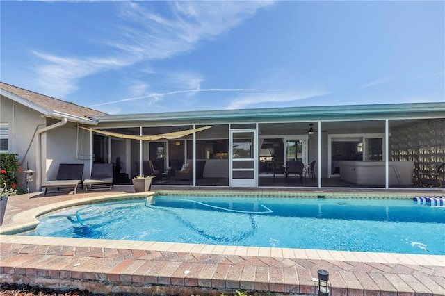 outdoor pool featuring a patio area and a sunroom