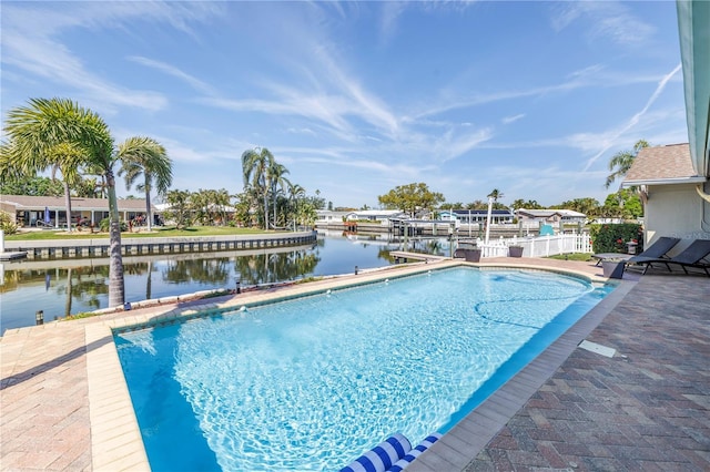 view of swimming pool featuring a water view and a patio area