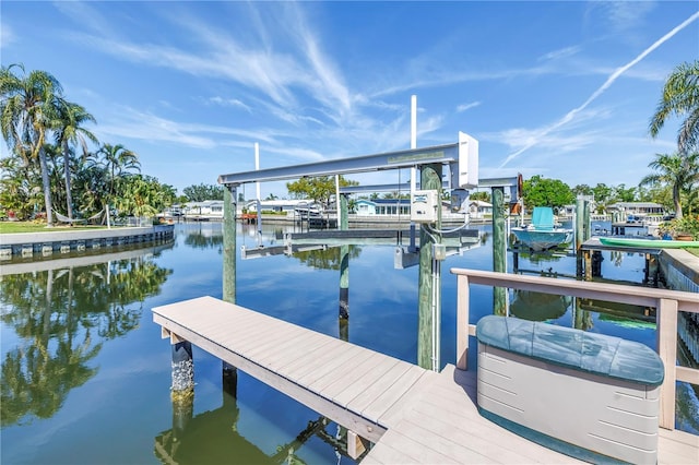 view of dock with boat lift and a water view