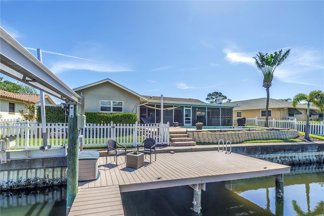 dock area with a water view and fence