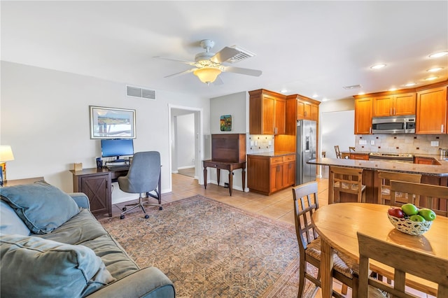 interior space featuring visible vents, baseboards, light tile patterned floors, recessed lighting, and a ceiling fan