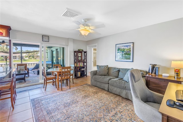 living area featuring visible vents, a ceiling fan, and tile patterned flooring