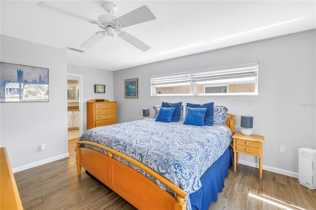 bedroom featuring baseboards, wood finished floors, and a ceiling fan
