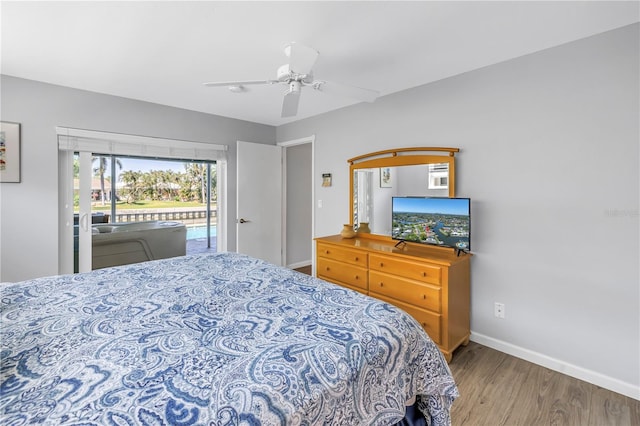 bedroom featuring access to exterior, ceiling fan, baseboards, and wood finished floors