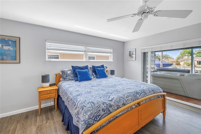 bedroom with baseboards, wood finished floors, and a ceiling fan