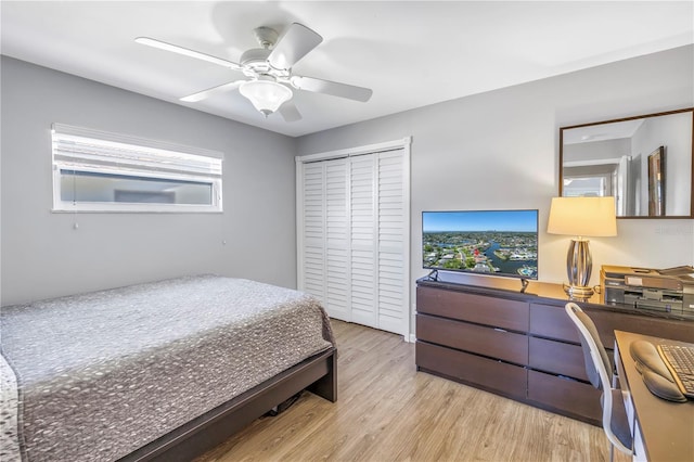 bedroom featuring a closet, wood finished floors, and a ceiling fan