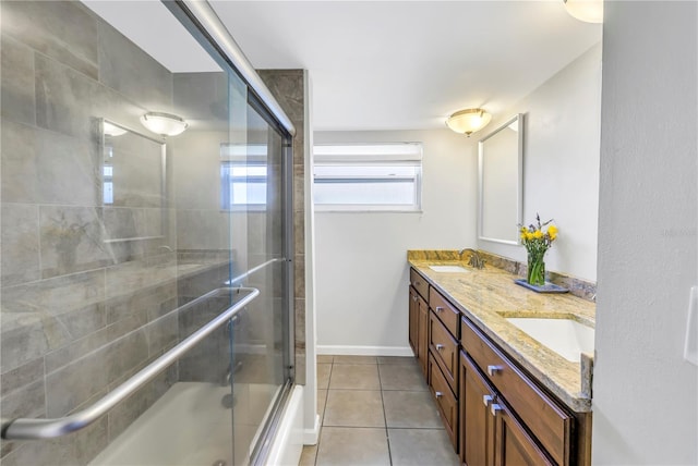 full bathroom featuring a sink, shower / bath combination with glass door, double vanity, and tile patterned floors