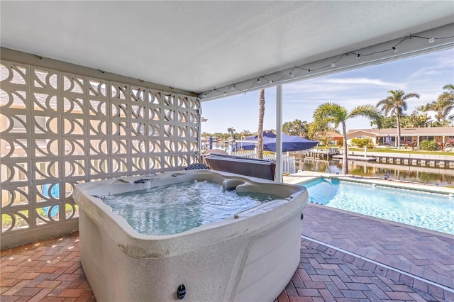 view of swimming pool with a fenced in pool, a patio area, and a hot tub