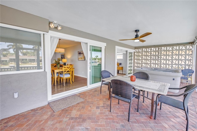 view of patio featuring outdoor dining space and a ceiling fan