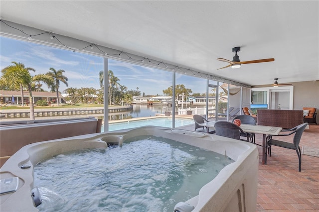 view of swimming pool featuring a water view, a ceiling fan, a patio, a pool, and a hot tub