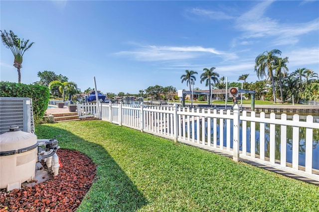 view of yard with fence and central AC