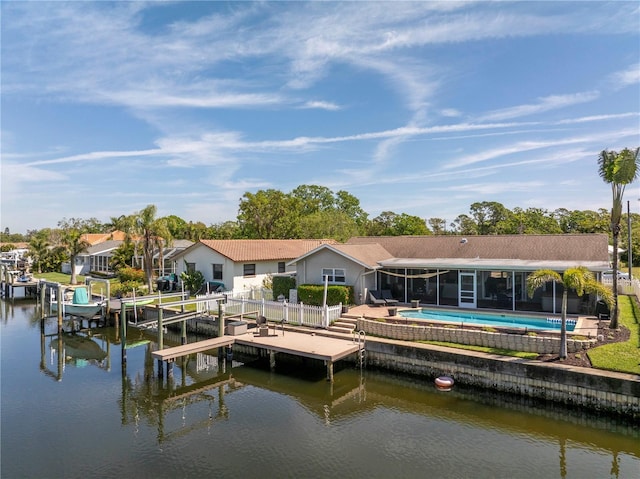 view of dock with boat lift, an outdoor pool, and a water view