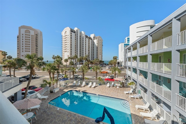 community pool featuring a city view and a patio area