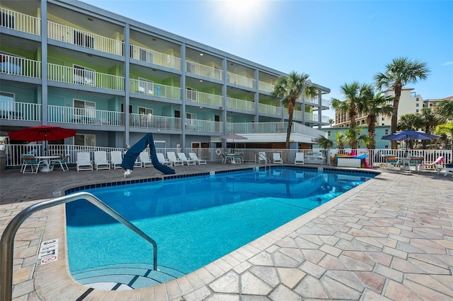 community pool featuring a patio and fence