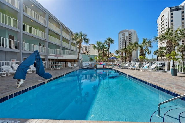 view of pool featuring a patio and fence