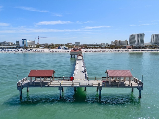 view of dock featuring a view of city and a water view