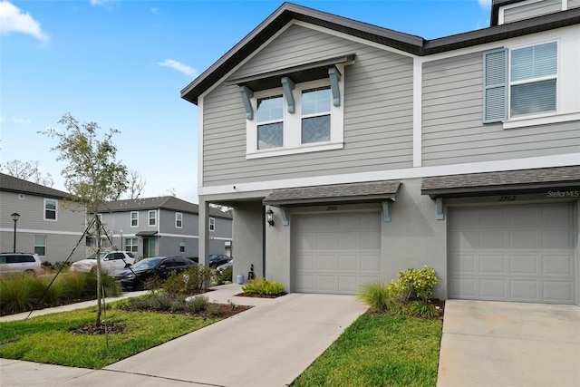 2760 Scarlet Bay Pl, Brandon, FL 33510 - multi unit property featuring concrete driveway, an attached garage, a residential view, and stucco siding