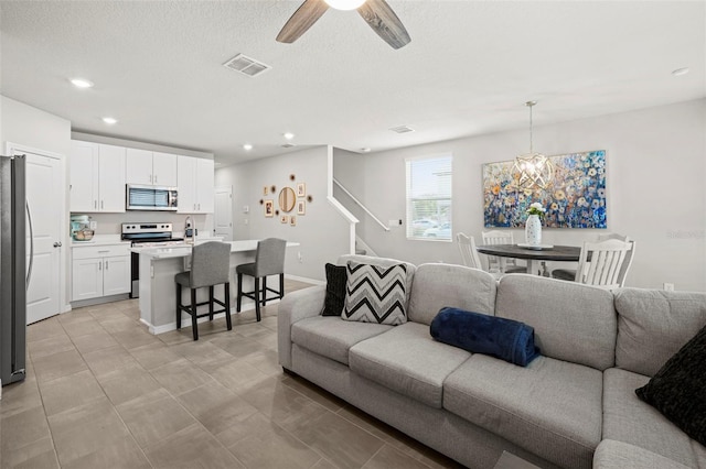 2760 Scarlet Bay Pl, Brandon, FL 33510 - living room featuring visible vents, ceiling fan, stairway, recessed lighting, and a textured ceiling